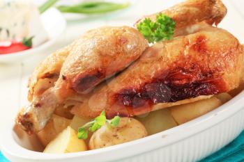 Roast chicken and new potatoes in a casserole dish