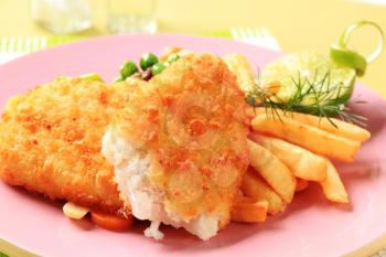 Fried breaded fish fillets with French fries and mixed vegetables