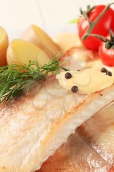 White fish fillets with new potatoes and Hollandaise sauce