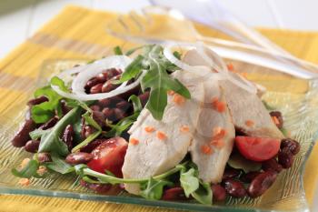 Slices of chicken breast fillet with lentil and bean salad