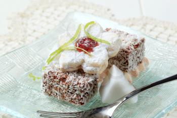 Chocolate dipped mini cakes coated in desiccated coconut