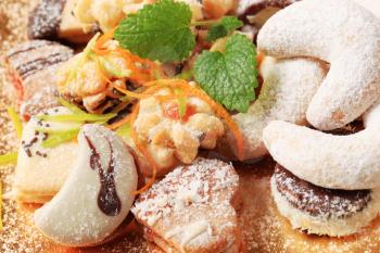 Variety of sweet cookies on golden plate