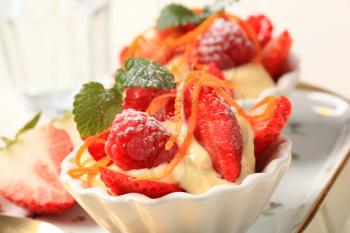 Creamy pudding with fresh strawberries and raspberries
