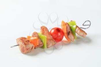 Pork skewer with pieces of fresh pepper