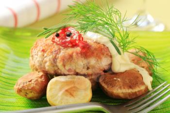 Meat patty with baked potatoes and mayonnaise