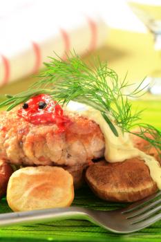 Meat patty with baked potatoes and mayonnaise