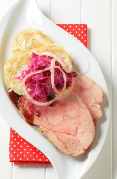Slices of pork with bread dumplings and red cabbage