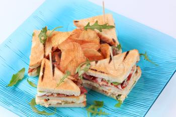 Turkey and bacon sandwiches and crisps - closeup