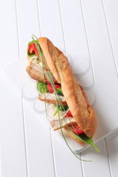 French bread filled with vegetables and chicken strips