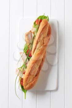 French bread filled with vegetables and chicken strips