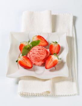 Scoop of strawberry ice cream with fresh fruit