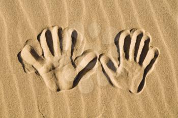 Hand prints in the sand  - macro
