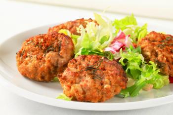Fried vegetable burgers with green salad