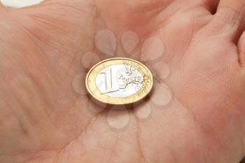 Euro coin on a mans palm