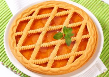 Round lattice topped apricot tart 