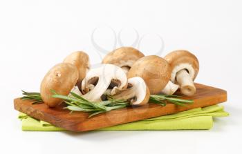 Fresh brown mushrooms on cutting board