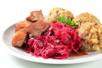 Dish of roast pork with Tyrolean dumplings and red cabbage