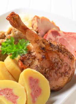 Roast duck leg and pork meat with potato dumplings 