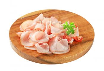 Thinly sliced turkey ham on cutting board