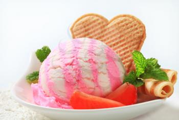Scoop of ice cream with strawberries and wafers