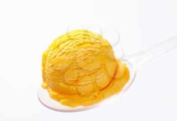 Scoop of yellow ice cream on a spoon