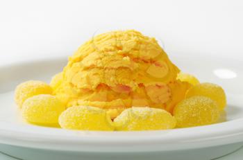Scoop of yellow ice cream with gelatin-based candy