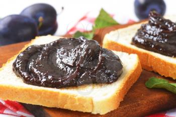 Slices of white bread with plum jam