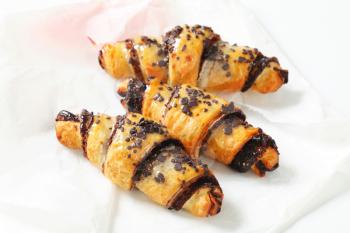 Chocolate-filled crescent rolls on paper 