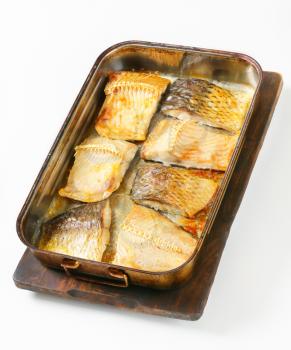 Oven baked carp fillets in baking pan