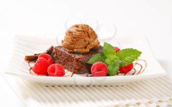 Chocolate brownie with ice cream and fresh raspberries
