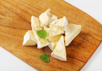 Pieces of French white rind cheese