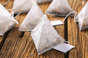 Jasmine tea bags on wood