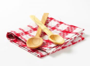 Red and white tea towel and wooden spoons