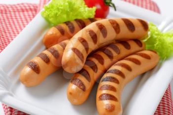 Grilled Vienna sausages  on white porcelain plate