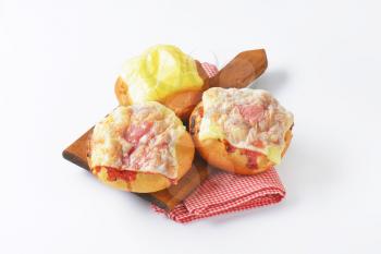 Bread rolls with slices of cheese and ham on top