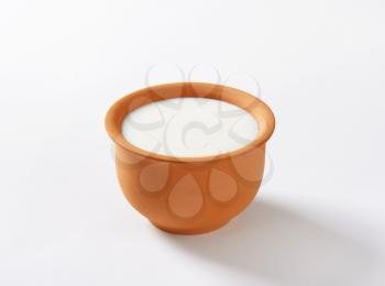 Fresh buttermilk in terracotta bowl