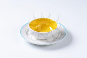 White and yellow coupe bowl and blue edged dinner plate