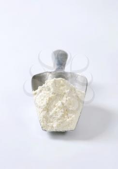 Metal scoop of finely ground flour
