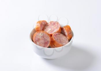 Sliced pork sausage in bowl