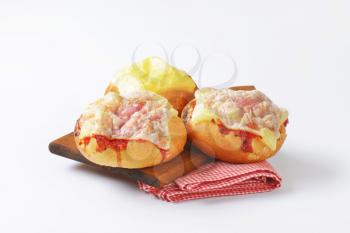 Bread rolls with slices of cheese and ham on top