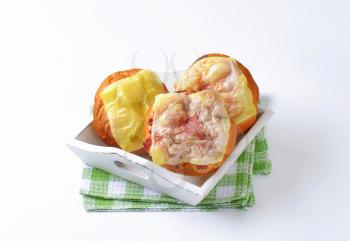 Bread buns with slices of cheese and ham on top