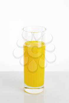 Yellow lemon juice drink served in tall glass