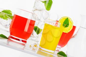 Glasses of fizzy water and fruit-flavored drinks