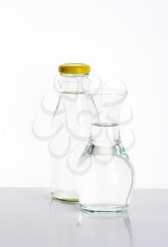 glass bottle and carafe of fresh water