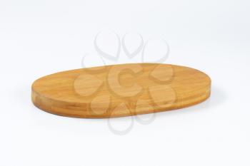 oval wooden cheese board on white background