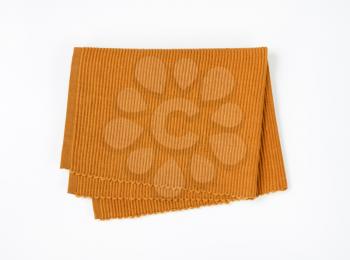 Folded brown cloth place mat