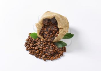 Roasted coffee beans in a burlap sack