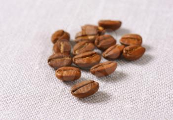 Roasted coffee beans on linen napkin