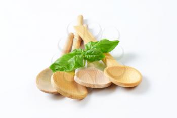variety of wooden spoons on off-white background