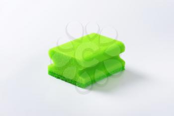 green kitchen sponge on white background